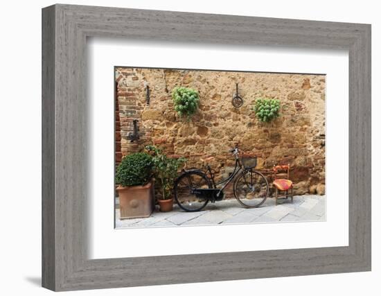 Italy, Tuscany, province of Siena, Chiusure. Hill town. Bicycle leans against stone wall.-Emily Wilson-Framed Photographic Print