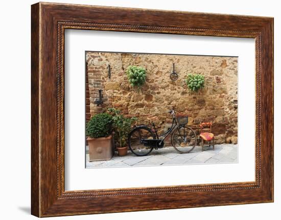 Italy, Tuscany, province of Siena, Chiusure. Hill town. Bicycle leans against stone wall.-Emily Wilson-Framed Photographic Print