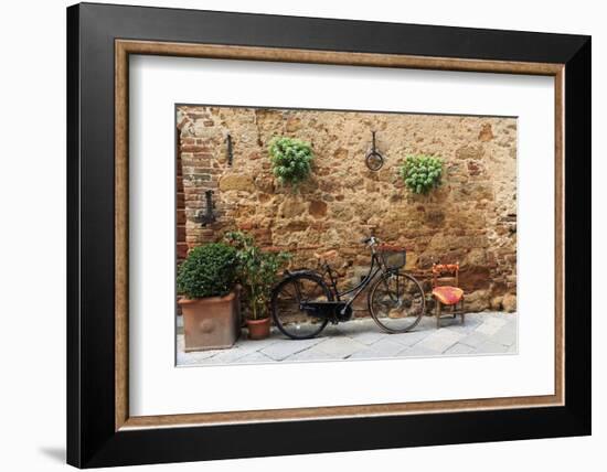 Italy, Tuscany, province of Siena, Chiusure. Hill town. Bicycle leans against stone wall.-Emily Wilson-Framed Photographic Print