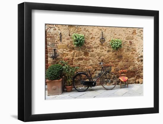 Italy, Tuscany, province of Siena, Chiusure. Hill town. Bicycle leans against stone wall.-Emily Wilson-Framed Photographic Print