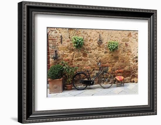 Italy, Tuscany, province of Siena, Chiusure. Hill town. Bicycle leans against stone wall.-Emily Wilson-Framed Photographic Print
