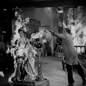 Actor Vincent Price Putting Out Fire in Film "House of Wax" by J^ R^ Eyerman
