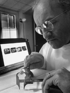 Dentist Dr. Harland Measuring Tooth to Be Used in Medical Dentistry by J^ R^ Eyerman