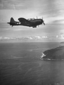 F-6 Hellcat Fighter Plane over Tanahmera Bay as Japanese Airfields at Hollandia, New Guinea by J^ R^ Eyerman