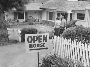 Realtor Pat Devault Showing a House to Her Clients by J^ R^ Eyerman