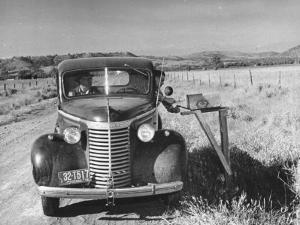 Sailor on Leave Dropping Mail into a Mailbox from an Automobile by J^ R^ Eyerman