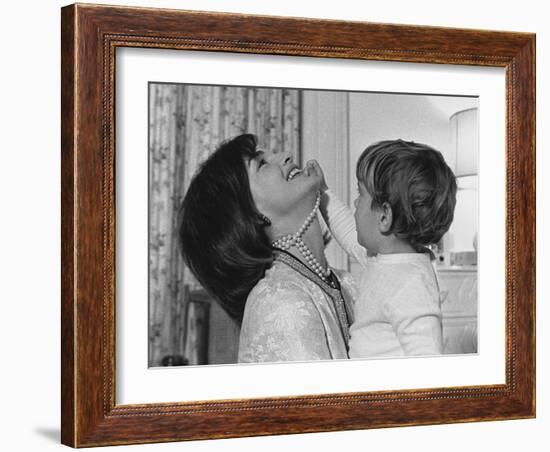 Jackie Kennedy Laughs as Her Son John Jr, Plays with Her Pearl Necklace, Nov.1962-null-Framed Photo