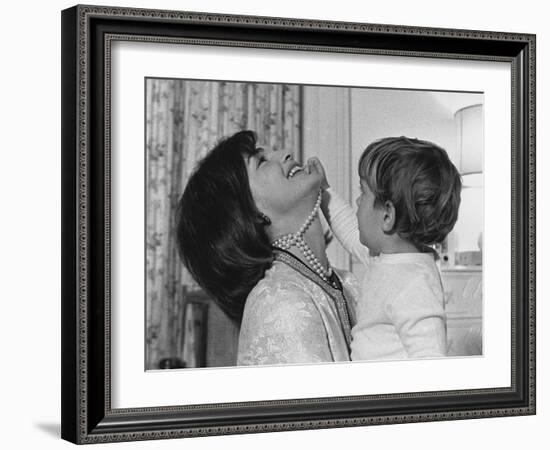 Jackie Kennedy Laughs as Her Son John Jr, Plays with Her Pearl Necklace, Nov.1962-null-Framed Photo