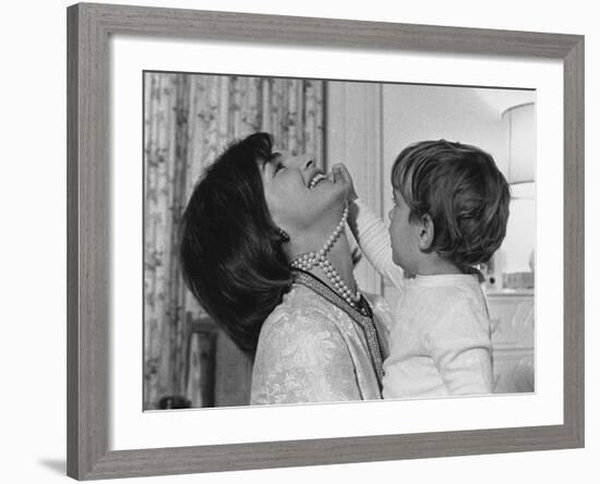 Jackie Kennedy Laughs as Her Son John Jr, Plays with Her Pearl Necklace, Nov.1962-null-Framed Photo