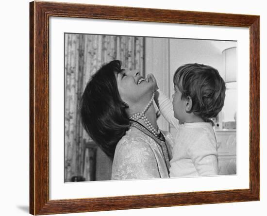 Jackie Kennedy Laughs as Her Son John Jr, Plays with Her Pearl Necklace, Nov.1962-null-Framed Photo