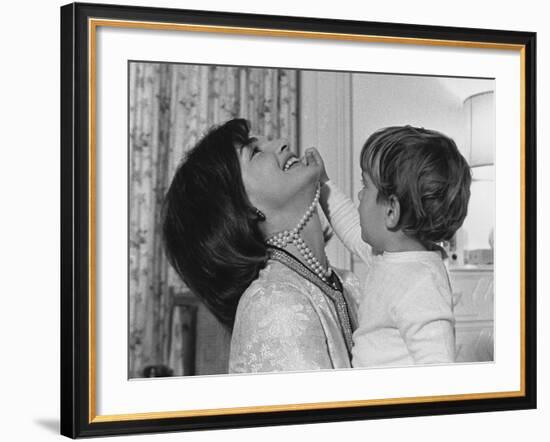 Jackie Kennedy Laughs as Her Son John Jr, Plays with Her Pearl Necklace, Nov.1962-null-Framed Photo