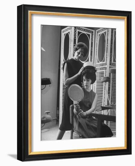 Jackie Kennedy Style Pillbox Hats Being Tried on by Models at Charles A. Stevens and Co-Francis Miller-Framed Photographic Print