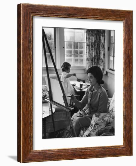 Jackie Kennedy, Wife of Sen, Painting on an easel as Daughter Caroline Paints on Table at Home-Alfred Eisenstaedt-Framed Photographic Print