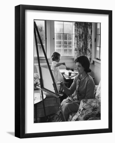 Jackie Kennedy, Wife of Sen, Painting on an easel as Daughter Caroline Paints on Table at Home-Alfred Eisenstaedt-Framed Photographic Print