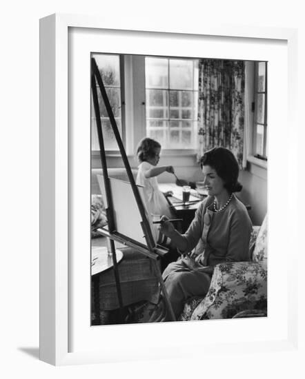 Jackie Kennedy, Wife of Sen, Painting on an easel as Daughter Caroline Paints on Table at Home-Alfred Eisenstaedt-Framed Photographic Print