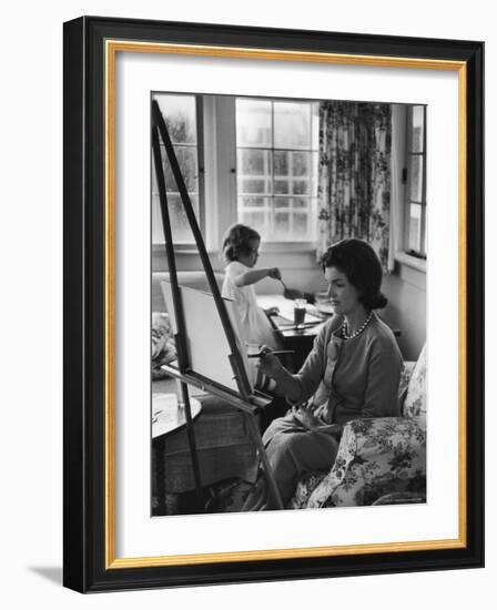 Jackie Kennedy, Wife of Sen, Painting on an easel as Daughter Caroline Paints on Table at Home-Alfred Eisenstaedt-Framed Photographic Print