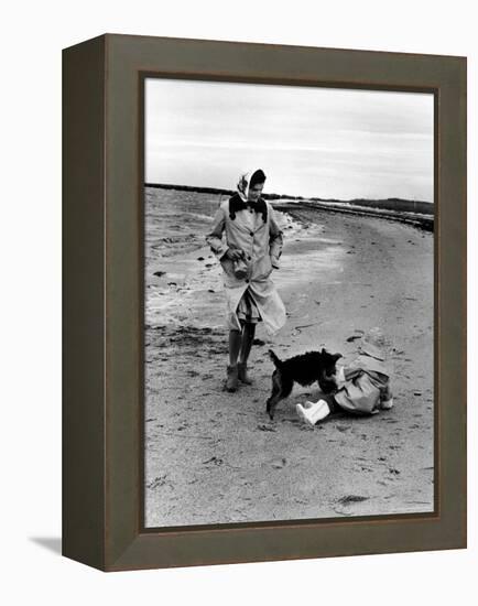 Jackie Kennedy, Wife of Sen, Walking Along Beach with Her Slicker Clad Daughter Caroline-Alfred Eisenstaedt-Framed Premier Image Canvas