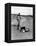 Jackie Kennedy, Wife of Sen, Walking Along Beach with Her Slicker Clad Daughter Caroline-Alfred Eisenstaedt-Framed Premier Image Canvas