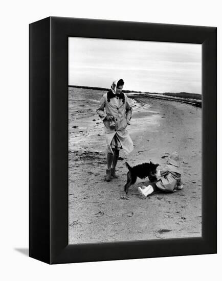 Jackie Kennedy, Wife of Sen, Walking Along Beach with Her Slicker Clad Daughter Caroline-Alfred Eisenstaedt-Framed Premier Image Canvas