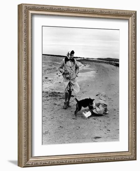 Jackie Kennedy, Wife of Sen, Walking Along Beach with Her Slicker Clad Daughter Caroline-Alfred Eisenstaedt-Framed Photographic Print