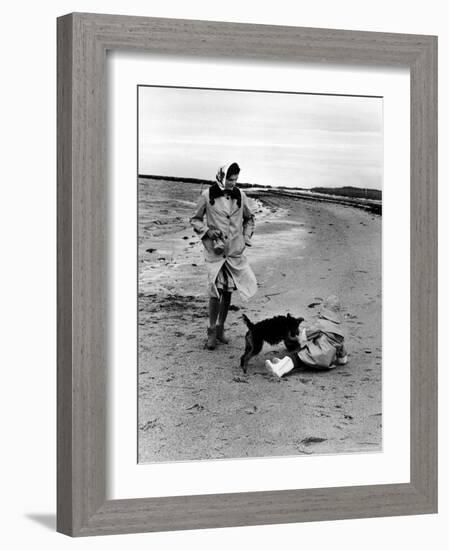 Jackie Kennedy, Wife of Sen, Walking Along Beach with Her Slicker Clad Daughter Caroline-Alfred Eisenstaedt-Framed Photographic Print