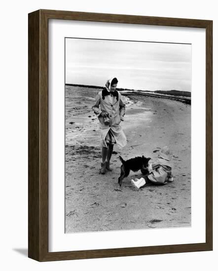 Jackie Kennedy, Wife of Sen, Walking Along Beach with Her Slicker Clad Daughter Caroline-Alfred Eisenstaedt-Framed Photographic Print