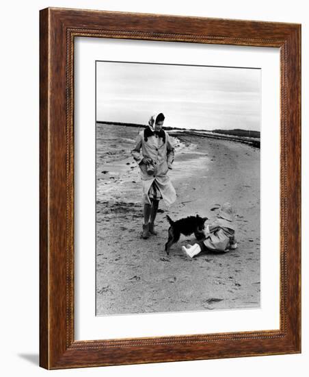 Jackie Kennedy, Wife of Sen, Walking Along Beach with Her Slicker Clad Daughter Caroline-Alfred Eisenstaedt-Framed Photographic Print