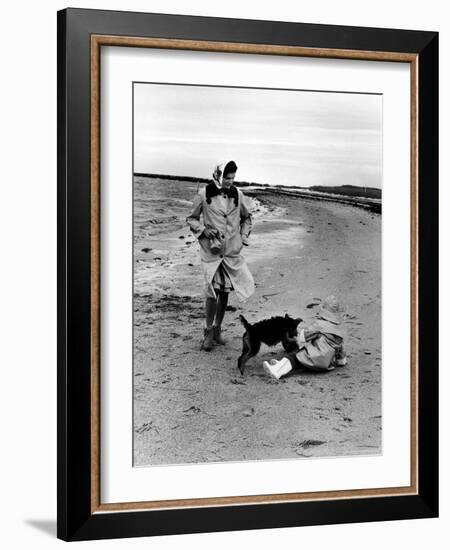 Jackie Kennedy, Wife of Sen, Walking Along Beach with Her Slicker Clad Daughter Caroline-Alfred Eisenstaedt-Framed Photographic Print