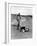 Jackie Kennedy, Wife of Sen, Walking Along Beach with Her Slicker Clad Daughter Caroline-Alfred Eisenstaedt-Framed Photographic Print