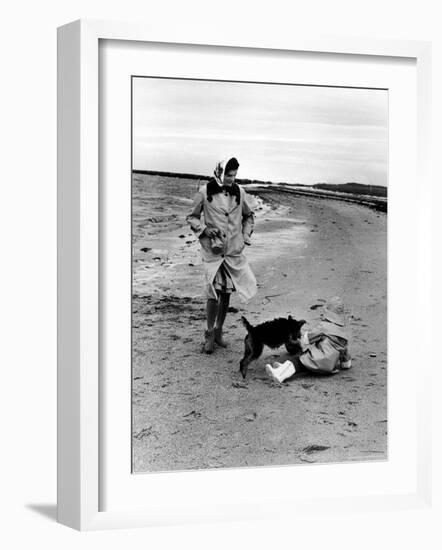 Jackie Kennedy, Wife of Sen, Walking Along Beach with Her Slicker Clad Daughter Caroline-Alfred Eisenstaedt-Framed Photographic Print