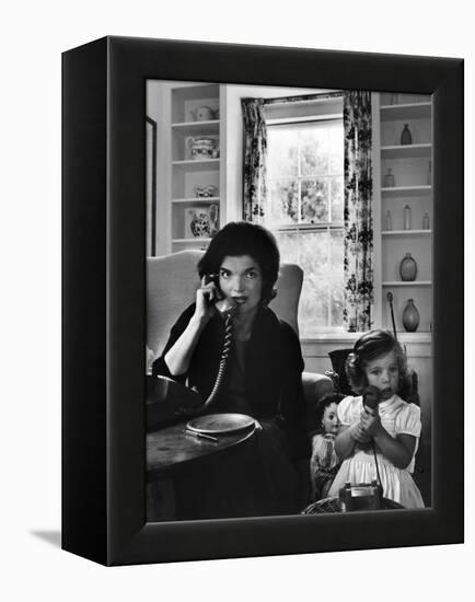 Jackie Kennedy, Wife of Senator John Kennedy, Talking on the Telephone as her daughter mimics her-Alfred Eisenstaedt-Framed Premier Image Canvas