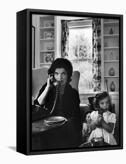 Jackie Kennedy, Wife of Senator John Kennedy, Talking on the Telephone as her daughter mimics her-Alfred Eisenstaedt-Framed Premier Image Canvas