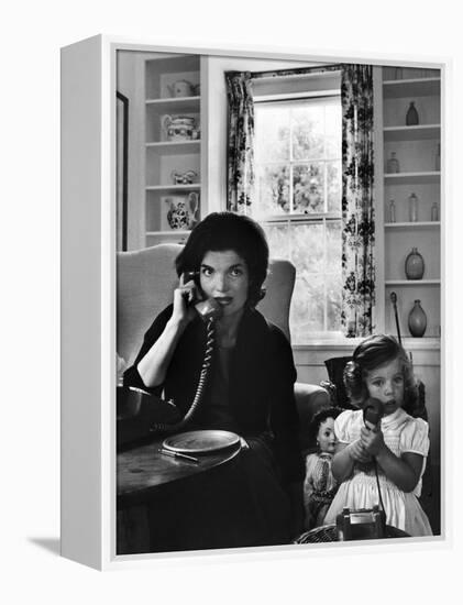 Jackie Kennedy, Wife of Senator John Kennedy, Talking on the Telephone as her daughter mimics her-Alfred Eisenstaedt-Framed Premier Image Canvas