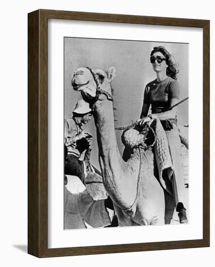 Jacqueline Kennedy Onassis Riding a Camel While on Vacation in Egypt, March 28, 1974-null-Framed Photo