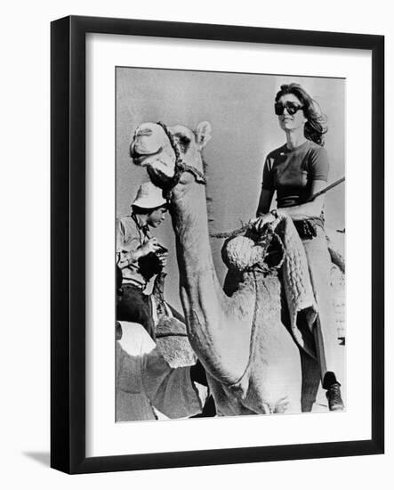 Jacqueline Kennedy Onassis Riding a Camel While on Vacation in Egypt, March 28, 1974-null-Framed Photo