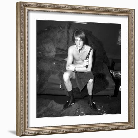 Jacques Dutronc Smoking a Cigarette and Holding a Revolver in 1971-Roldes-Framed Photographic Print