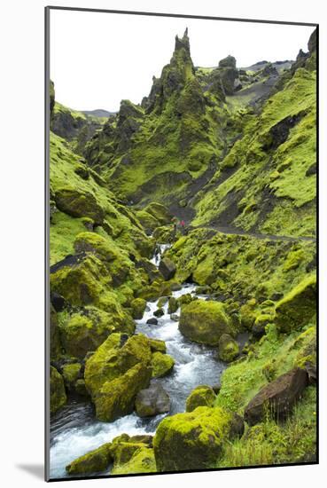 Jagged Moss Covered Peaks With A Mountain Stream Running Through With Hikers In The Distance-Erik Kruthoff-Mounted Photographic Print