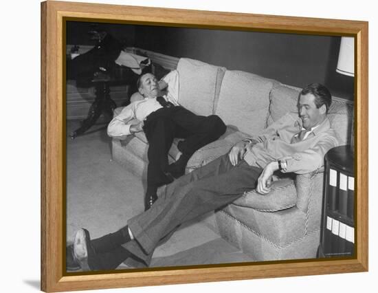 James Stewart Stretched Out on Office Sofa, Smiling, Producer Leland Hayward Slouches at Other End-John Florea-Framed Premier Image Canvas