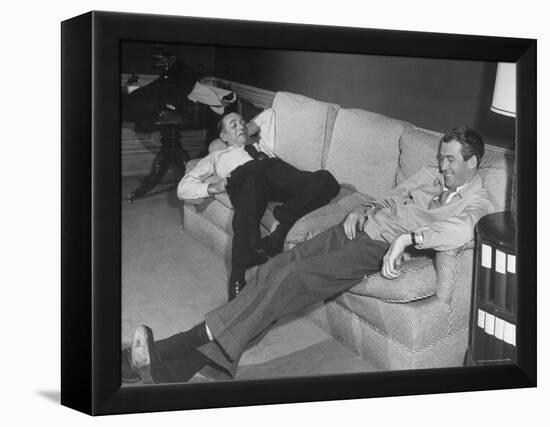 James Stewart Stretched Out on Office Sofa, Smiling, Producer Leland Hayward Slouches at Other End-John Florea-Framed Premier Image Canvas