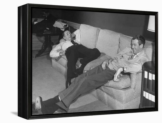 James Stewart Stretched Out on Office Sofa, Smiling, Producer Leland Hayward Slouches at Other End-John Florea-Framed Premier Image Canvas