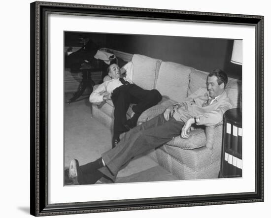 James Stewart Stretched Out on Office Sofa, Smiling, Producer Leland Hayward Slouches at Other End-John Florea-Framed Premium Photographic Print