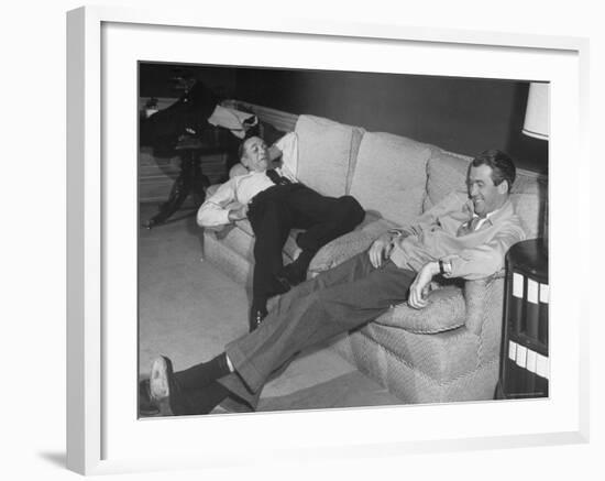 James Stewart Stretched Out on Office Sofa, Smiling, Producer Leland Hayward Slouches at Other End-John Florea-Framed Premium Photographic Print