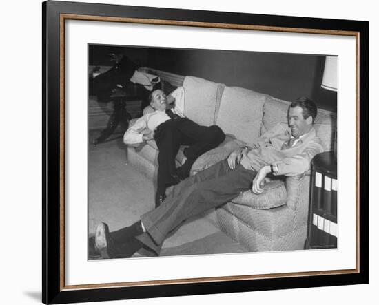 James Stewart Stretched Out on Office Sofa, Smiling, Producer Leland Hayward Slouches at Other End-John Florea-Framed Premium Photographic Print