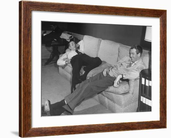 James Stewart Stretched Out on Office Sofa, Smiling, Producer Leland Hayward Slouches at Other End-John Florea-Framed Premium Photographic Print