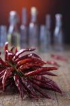 Dried Chillipods Hang Infront of Wooden Wall with Culinary Utensils-Jana Ihle-Photographic Print