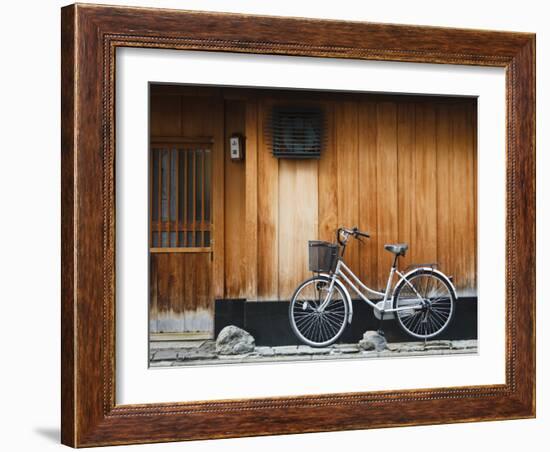 Japan, Chubu Region, Kyoto, Gion, a Bicycle Rests Against the Wall of a Traditional Building-Nick Ledger-Framed Photographic Print