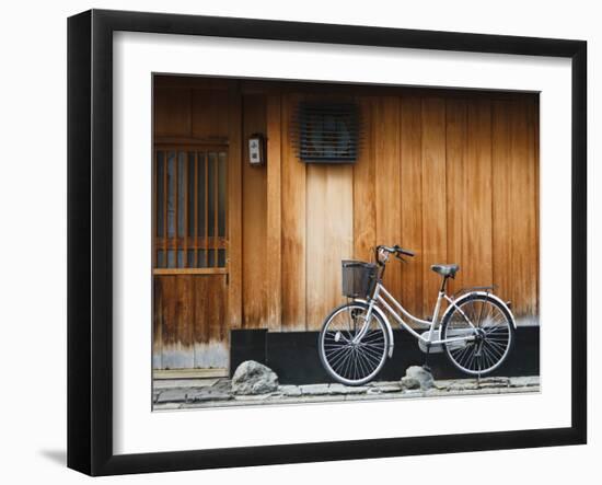 Japan, Chubu Region, Kyoto, Gion, a Bicycle Rests Against the Wall of a Traditional Building-Nick Ledger-Framed Photographic Print