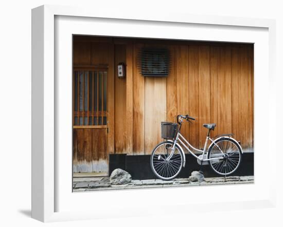 Japan, Chubu Region, Kyoto, Gion, a Bicycle Rests Against the Wall of a Traditional Building-Nick Ledger-Framed Photographic Print