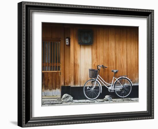 Japan, Chubu Region, Kyoto, Gion, a Bicycle Rests Against the Wall of a Traditional Building-Nick Ledger-Framed Photographic Print