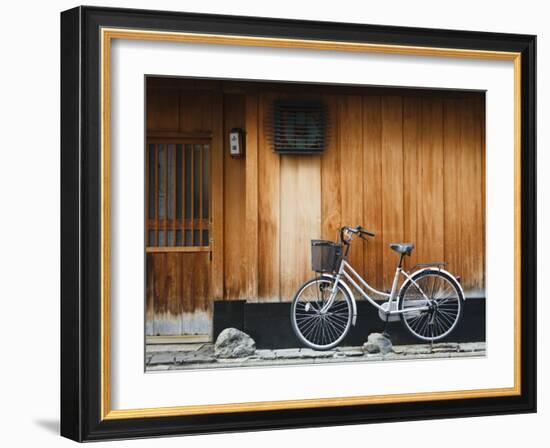 Japan, Chubu Region, Kyoto, Gion, a Bicycle Rests Against the Wall of a Traditional Building-Nick Ledger-Framed Photographic Print